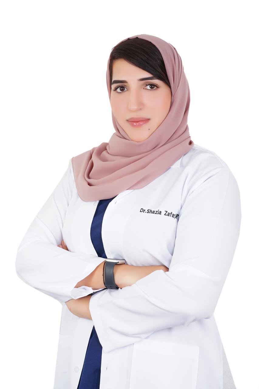 Dr. Shazia Balouch, Lead Physiotherapist, in a white clinical coat